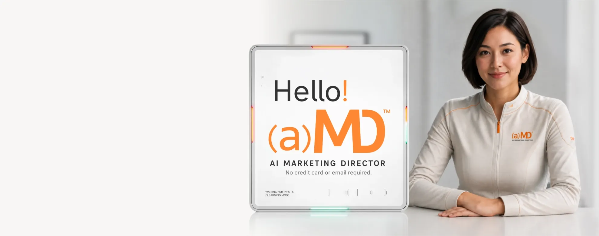 An (a)MD™ unit showing its Hello screen, with a Magnifire team member seated beside it.